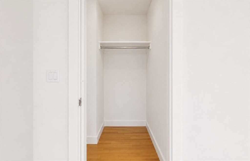 400 Stuart Street, Unit 18G Boston, MA 02116 - Photo 9 of 20 a view of a hallway with white walls