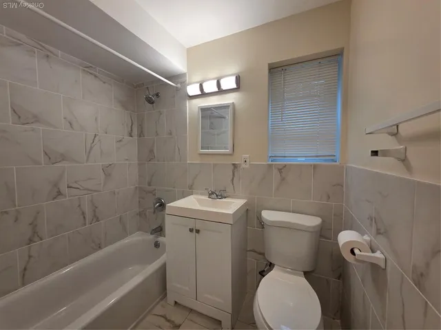 a bathroom with a sink toilet and bathtub