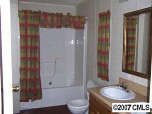 1655 Ruth Street Lancaster, SC 29720 - Photo 2 of 5 a bathroom with a sink and a mirror