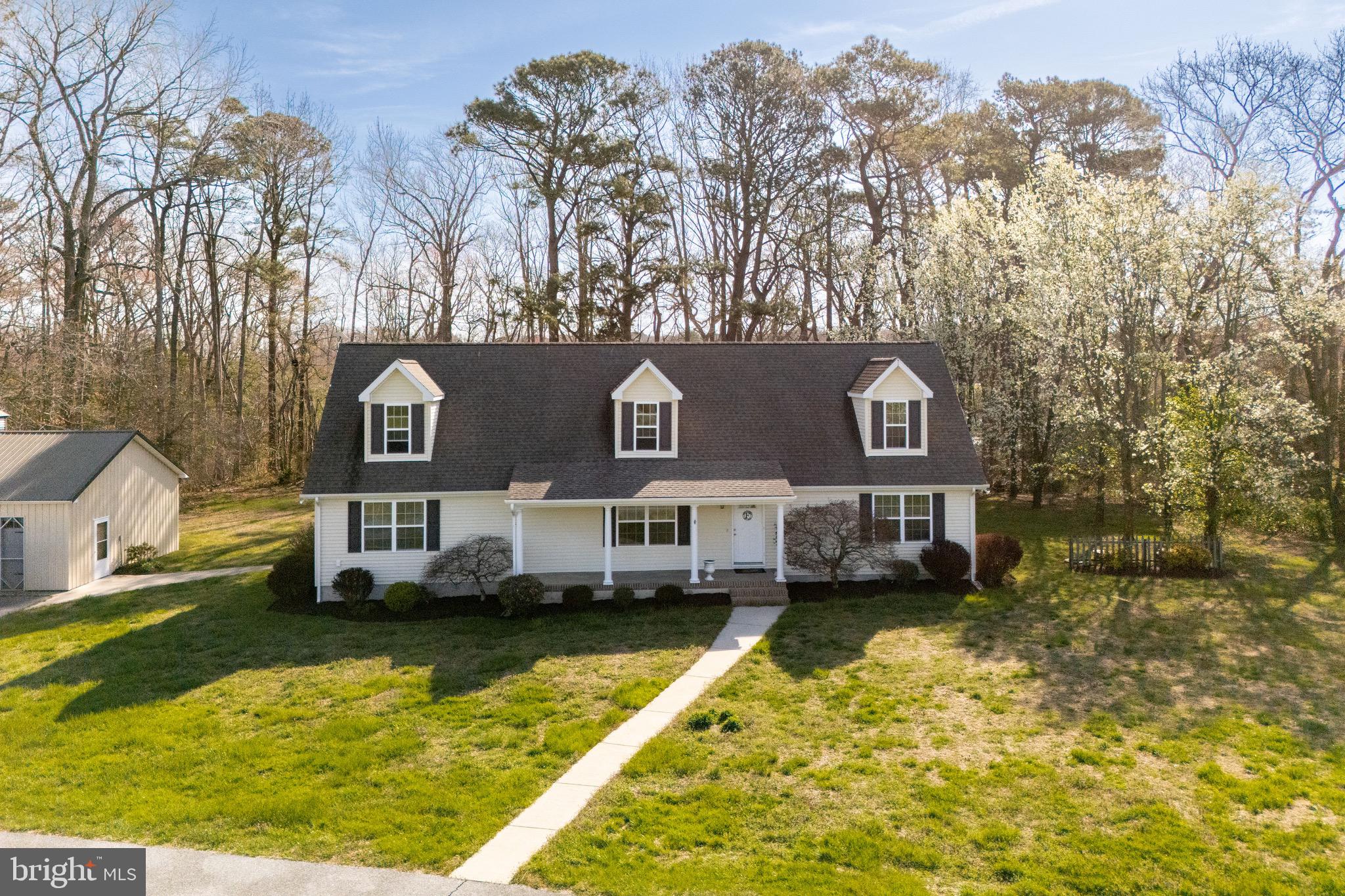 12740 Jarvis Road Bishopville, MD 21813 - Photo 3 of 47 a front view of a house with a yard water fountain and a large tree