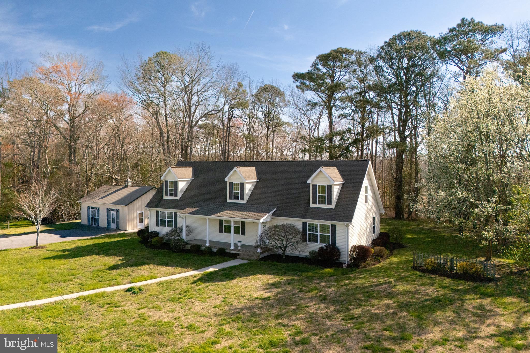 12740 Jarvis Road Bishopville, MD 21813 - Photo 4 of 47 a front view of a house with a yard garage and outdoor seating