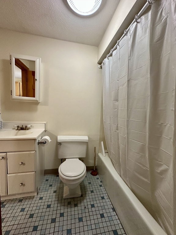 5 Rifle Court, Unit 5 Watertown, MA 02472 - Photo 7 of 14 a bathroom with a toilet a sink and a shower