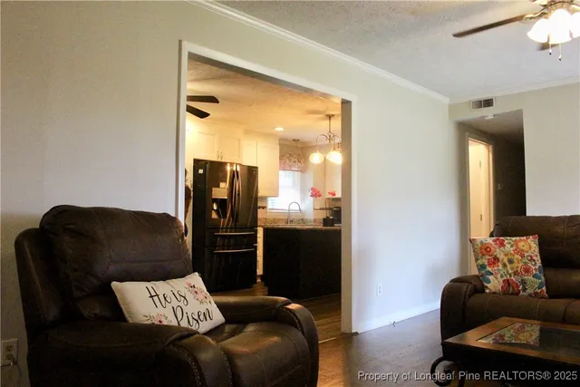 a kitchen with kitchen island a sink stainless steel appliances and refrigerator