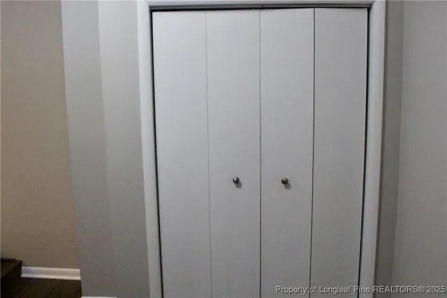 a view of hallway with a car parked in a yard