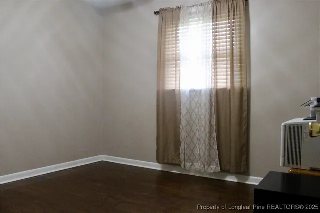 a bedroom with a bed and a mirror on dresser