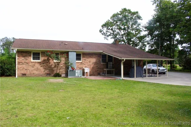 a front view of house with yard and outdoor seating