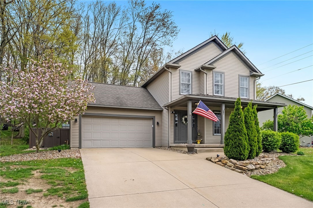 1247 Derbydale Road Akron, OH 44306 - Photo 1 of 45 View of front of house with covered porch, driveway, a garage, and fence