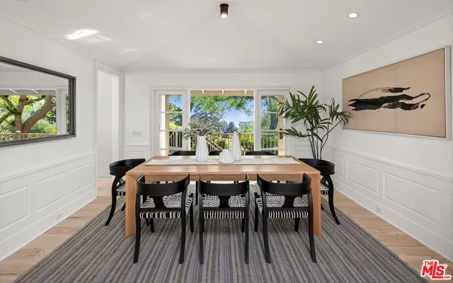 a bed sitting in a spacious bedroom next to a window