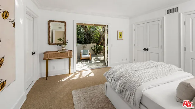 a bed room with a bed and a window