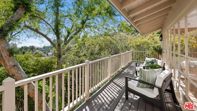 a view of a two chairs in the balcony