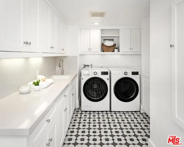a bathroom with a sink a stove and cabinets