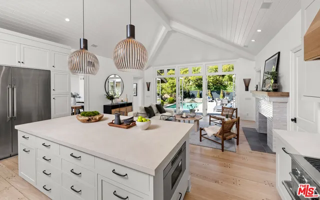 a kitchen with sink cabinets and living room view