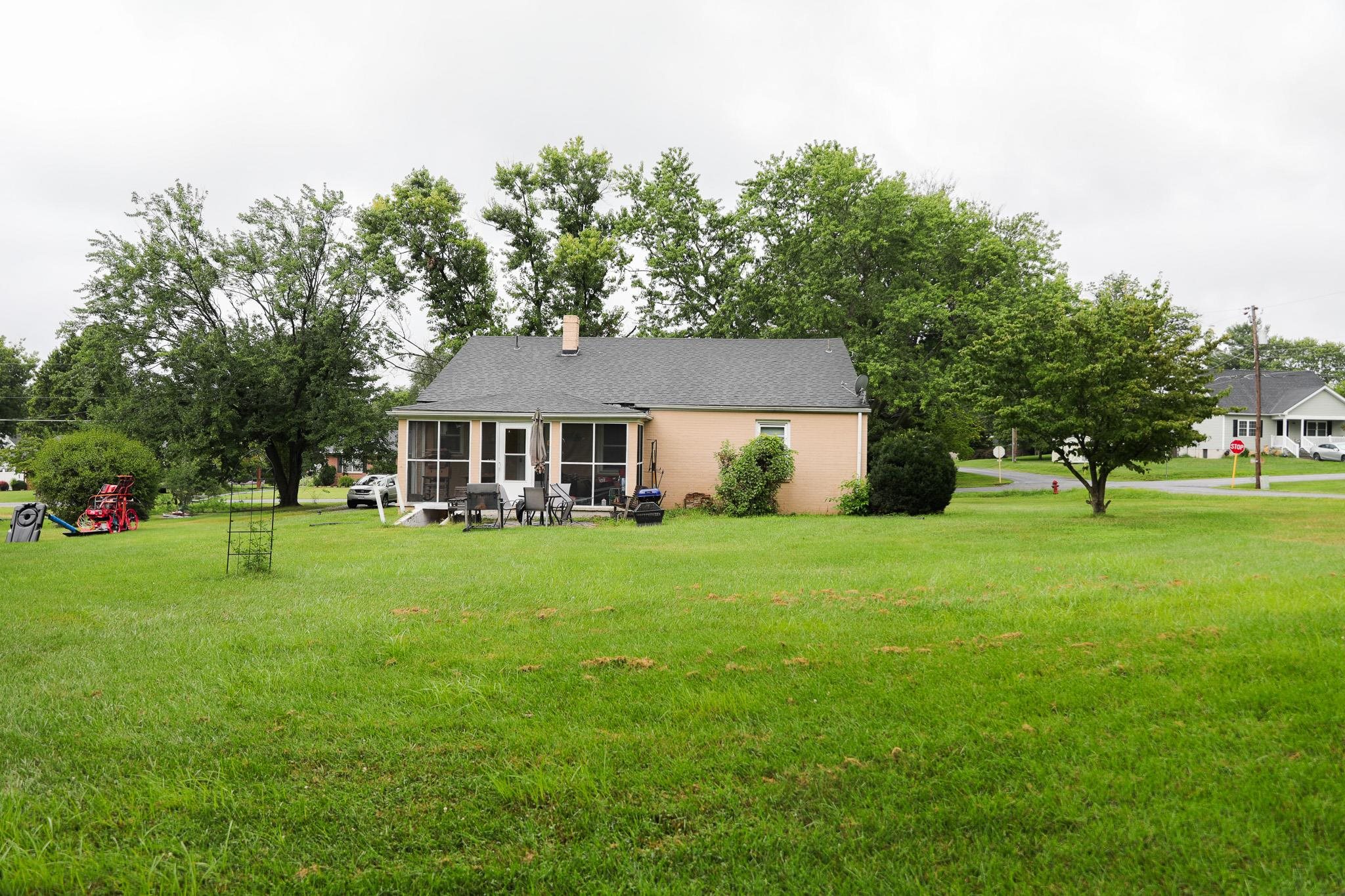 44 Stuart Avenue Stuarts Draft, VA 24477 - Photo 15 of 19 a front view of a house with a yard and trees
