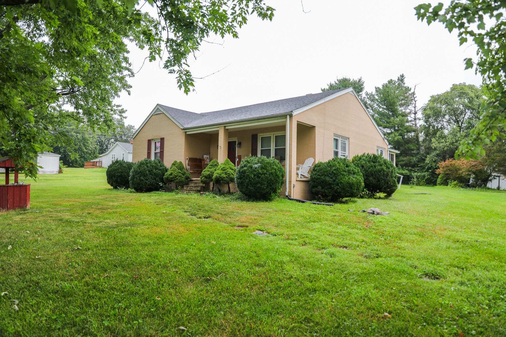 44 Stuart Avenue Stuarts Draft, VA 24477 - Photo 2 of 19 a house with green field in front of it