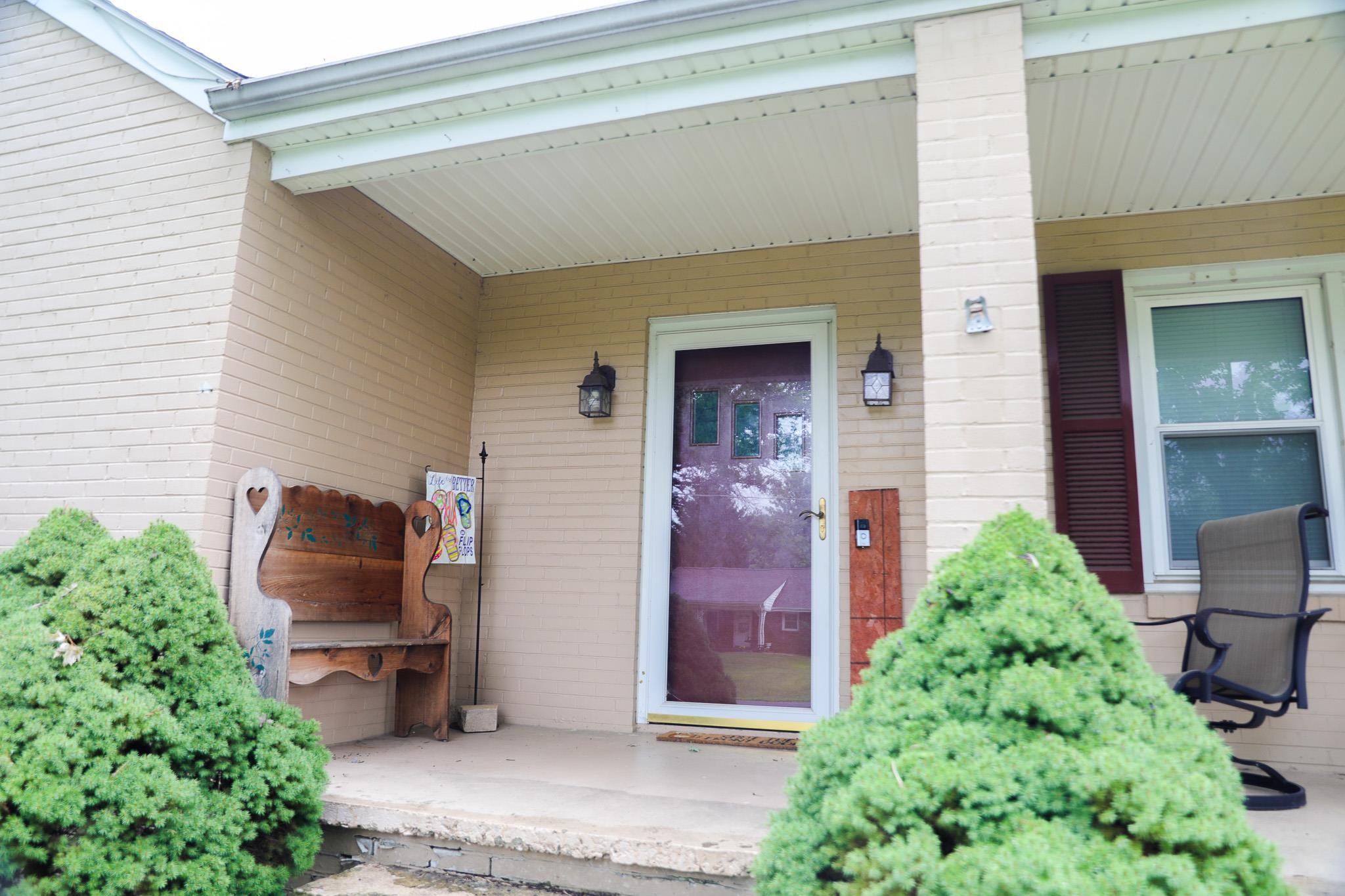 44 Stuart Avenue Stuarts Draft, VA 24477 - Photo 4 of 19 a backyard of a house with outdoor seating and plants