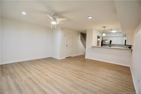 a view of a kitchen with a sink and a refrigerator