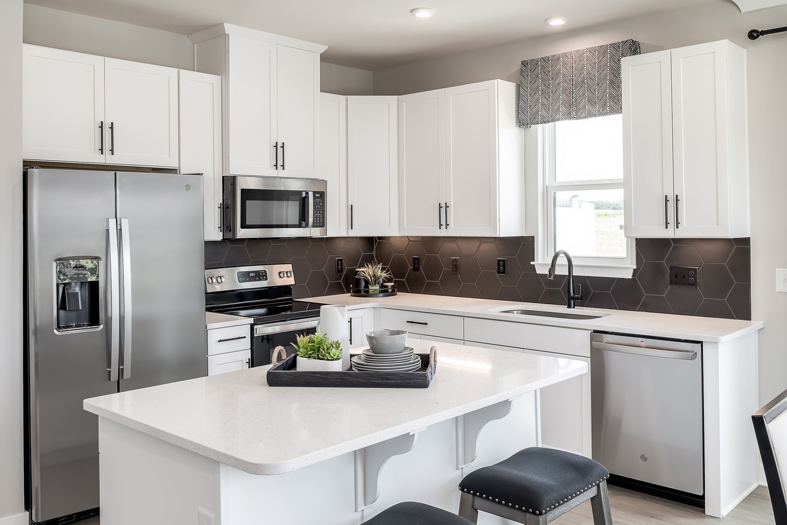 1013 Riverbrook Drive Gallatin, TN 37066 - Photo 11 of 30 a kitchen with refrigerator a stove a sink and white cabinets