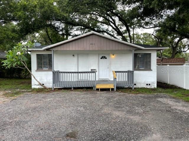 a view of a house with a yard and fence