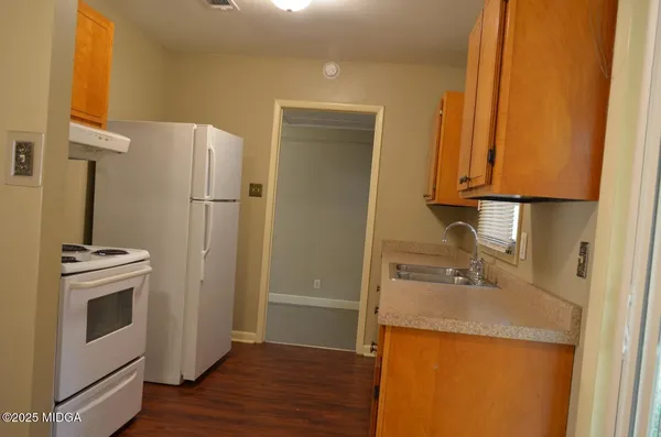 a kitchen with a refrigerator sink and stove