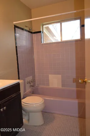 a white toilet sitting next to a bathroom sink