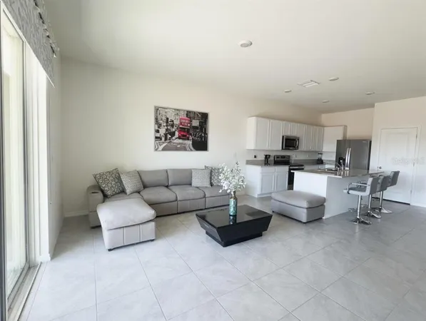 a living room with fireplace furniture and white walls