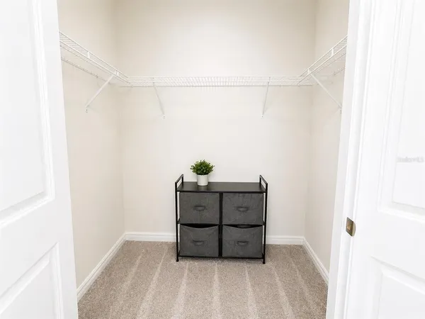 a bedroom with a bed and a night stand