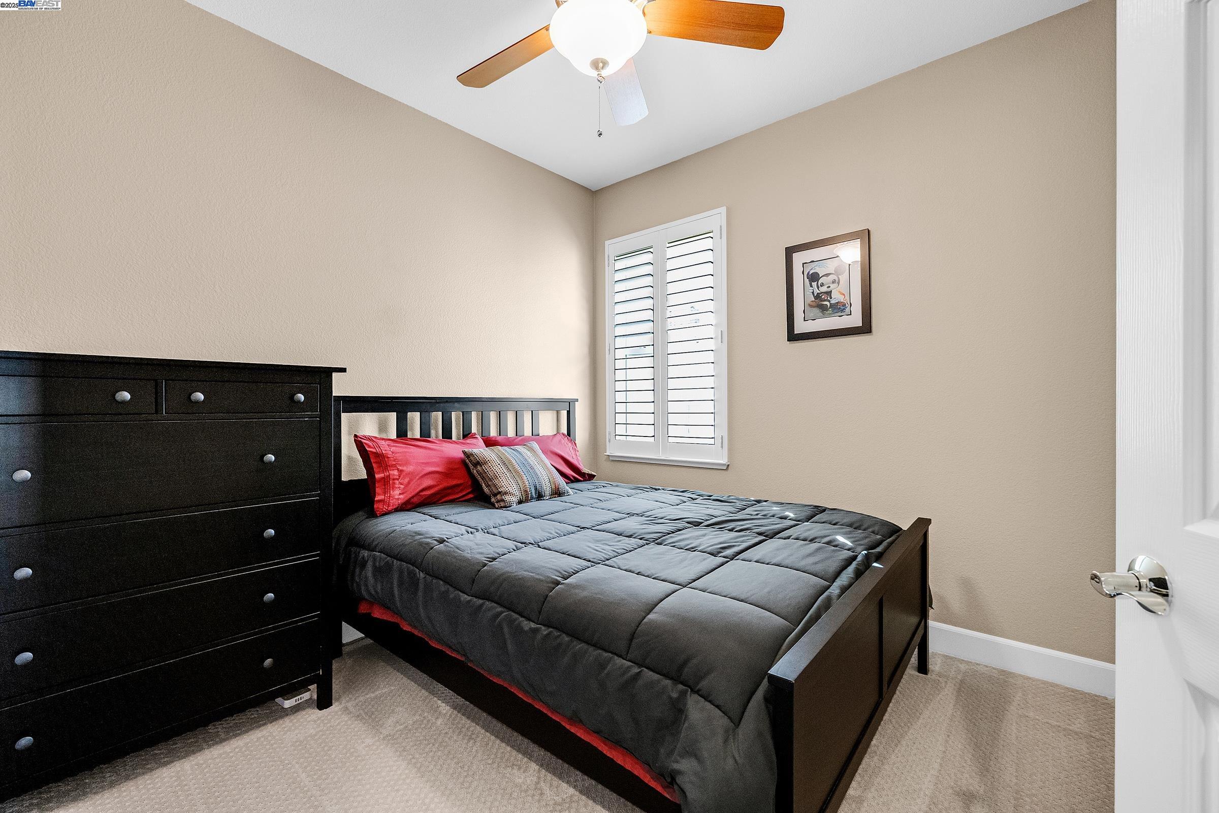 588 Dovecote Lane, Unit 4 Livermore, CA 94551 - Photo 11 of 21 a bedroom with a bed and a window