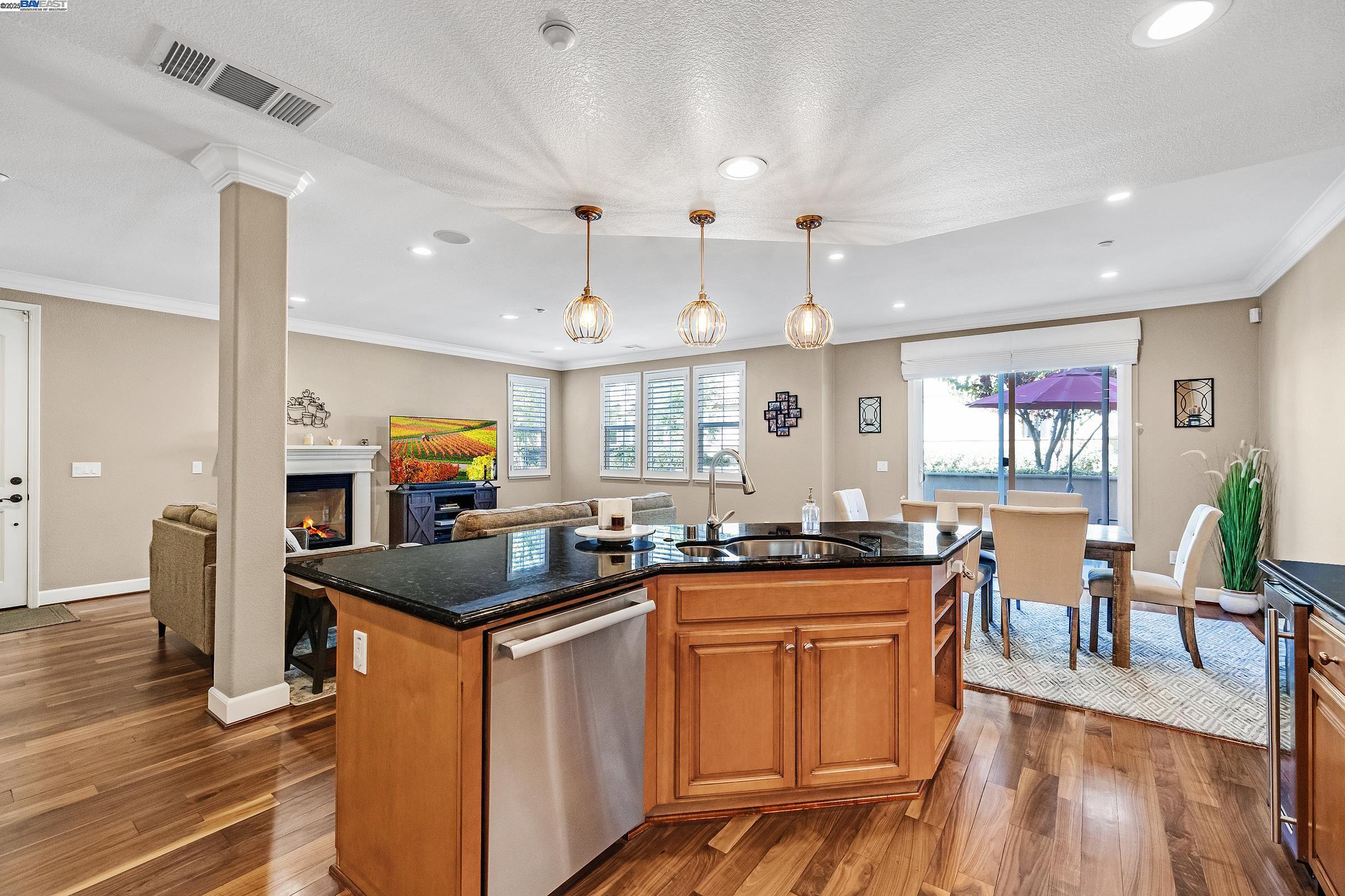 588 Dovecote Lane, Unit 4 Livermore, CA 94551 - Photo 4 of 21 a kitchen with granite countertop a sink stove cabinets and wooden floor
