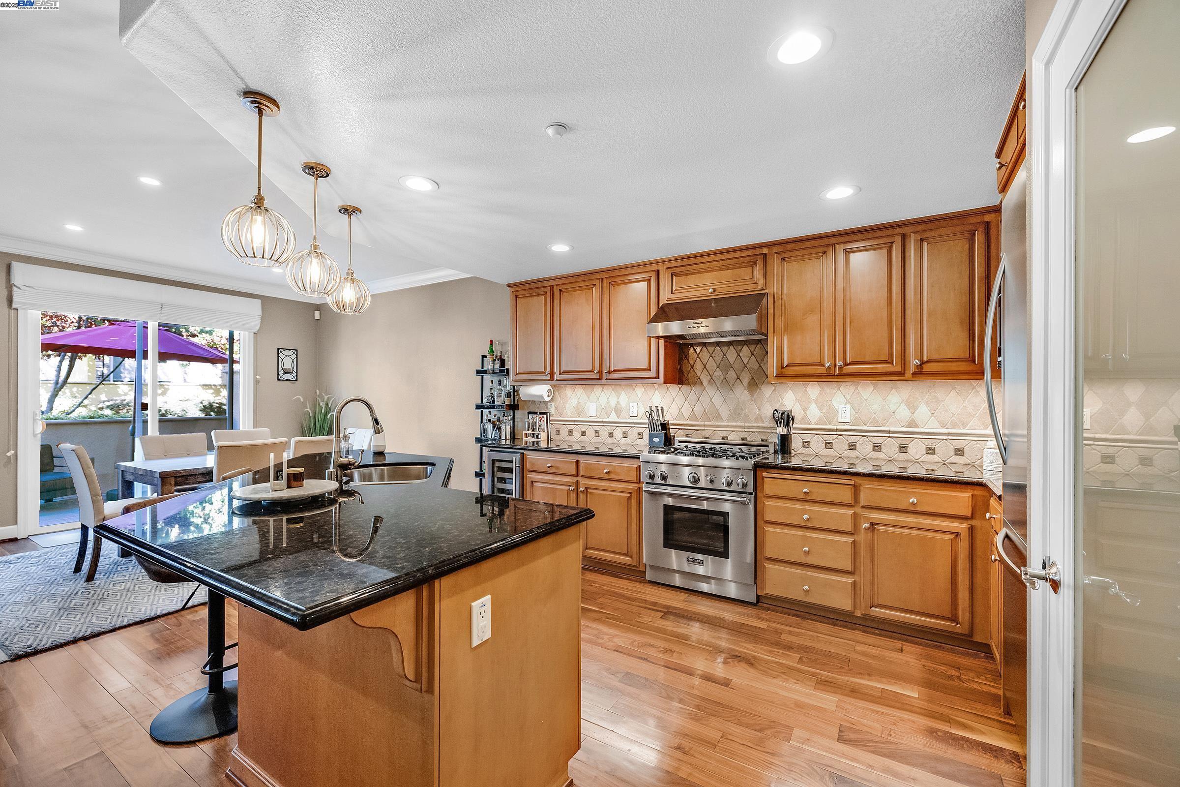 588 Dovecote Lane, Unit 4 Livermore, CA 94551 - Photo 6 of 21 a kitchen with stainless steel appliances granite countertop a stove refrigerator and a sink