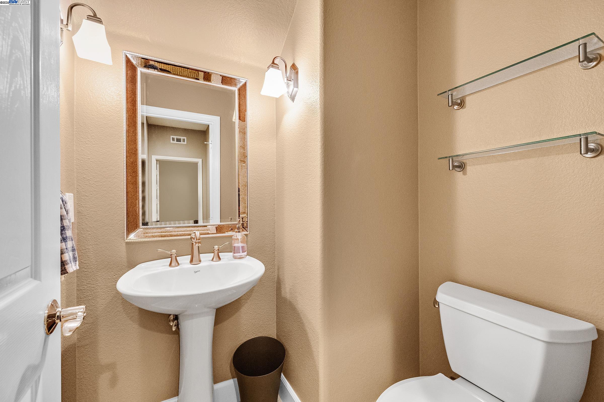 588 Dovecote Lane, Unit 4 Livermore, CA 94551 - Photo 7 of 21 a bathroom with a toilet sink and mirror