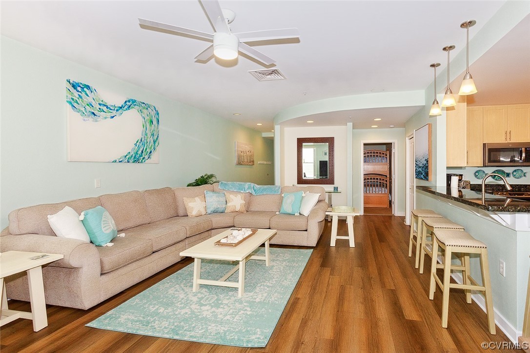 3738 Sandpiper Road, Unit 108B Virginia Beach, VA 23456 - Photo 11 of 31 a living room with furniture wooden floor and a table