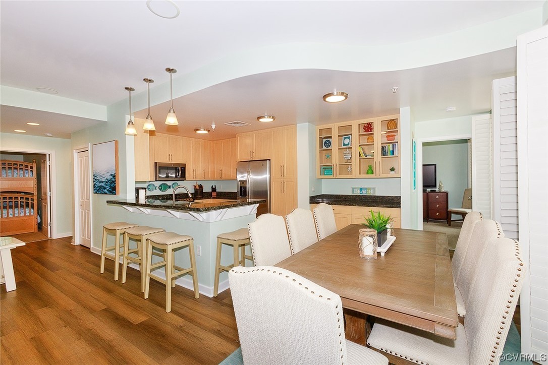 3738 Sandpiper Road, Unit 108B Virginia Beach, VA 23456 - Photo 12 of 31 a kitchen with a dining table chairs and view living room