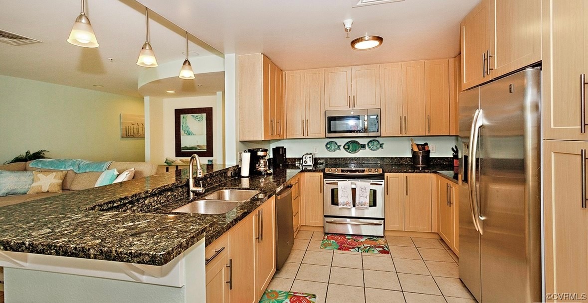 3738 Sandpiper Road, Unit 108B Virginia Beach, VA 23456 - Photo 14 of 31 a kitchen with stainless steel appliances granite countertop a sink stove and refrigerator
