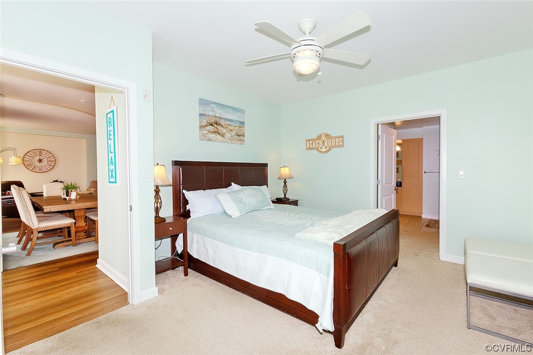 3738 Sandpiper Road, Unit 108B Virginia Beach, VA 23456 - Photo 16 of 31 a bedroom with a bed and a chandelier
