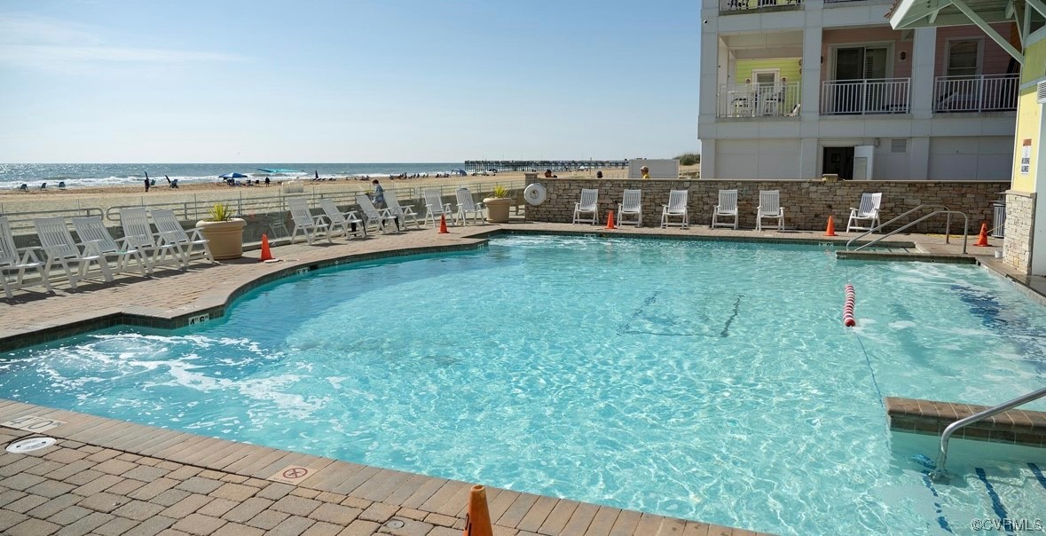 3738 Sandpiper Road, Unit 108B Virginia Beach, VA 23456 - Photo 25 of 31 a view of a swimming pool with an outdoor seating and a yard