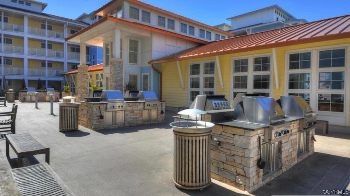 3738 Sandpiper Road, Unit 108B Virginia Beach, VA 23456 - Photo 29 of 31 a front view of a building with outdoor seating