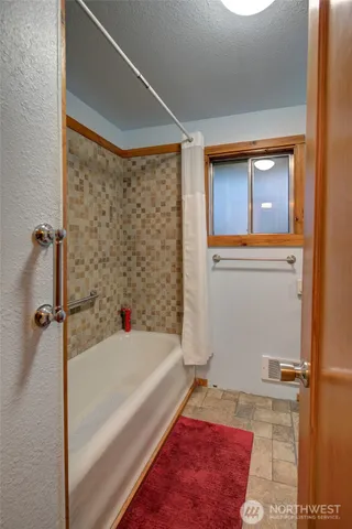 a bathroom with a bathtub and a shower