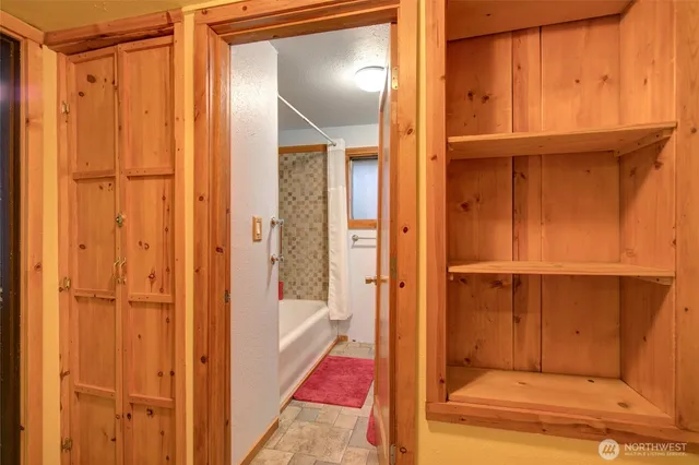 a view of bathroom with a shower and a door
