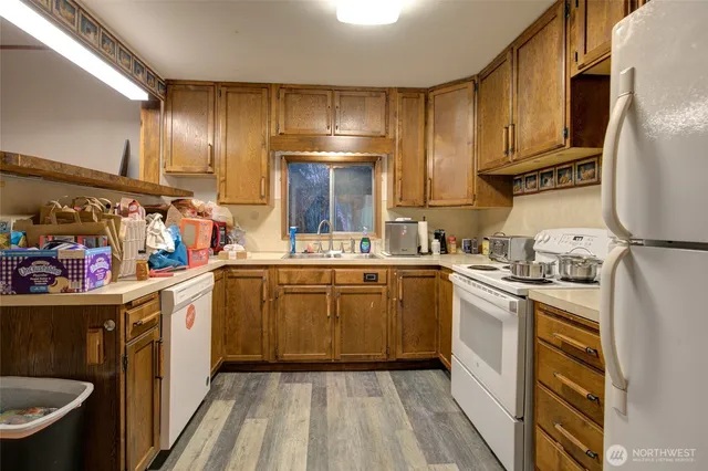 a kitchen with cabinets a sink and appliances