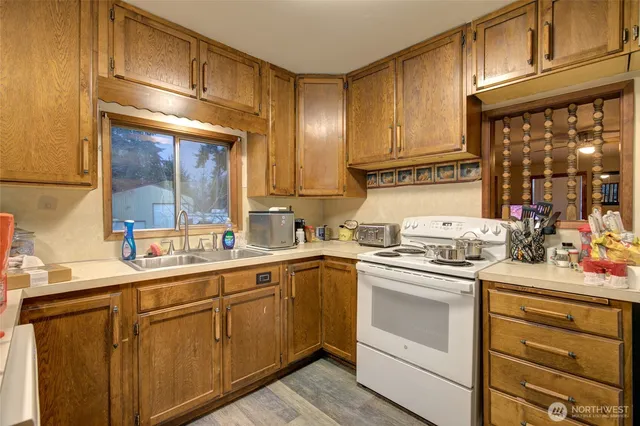 a kitchen with a sink stove and cabinets