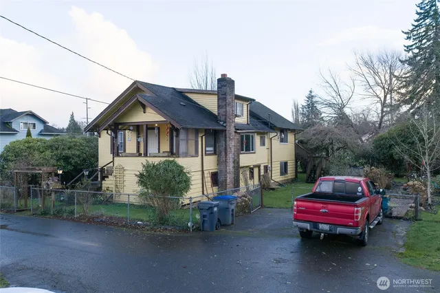 a front view of a house with a garden and plants