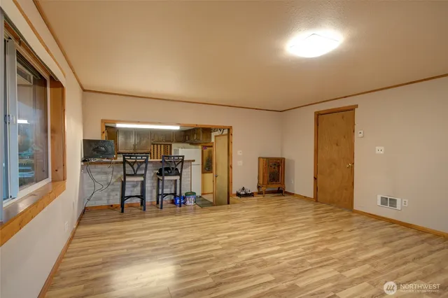 a view of a room with wooden floor