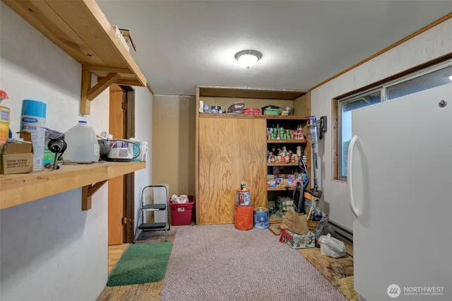 a view of game room with window and refrigerator