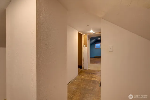 a view of a hallway with wooden shelves