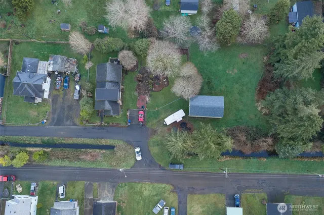 an aerial view of residential houses with outdoor space and parking