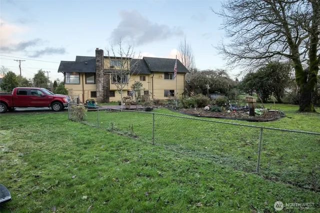 a view of a house with backyard sitting area and garden