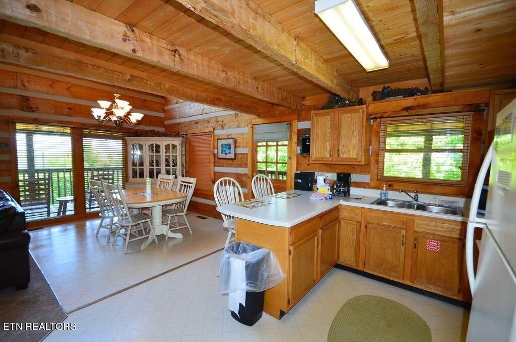2165 Rising Fawn Way Sevierville, TN 37862 - Photo 13 of 24 a dining table with chairs in front of it and kitchen view