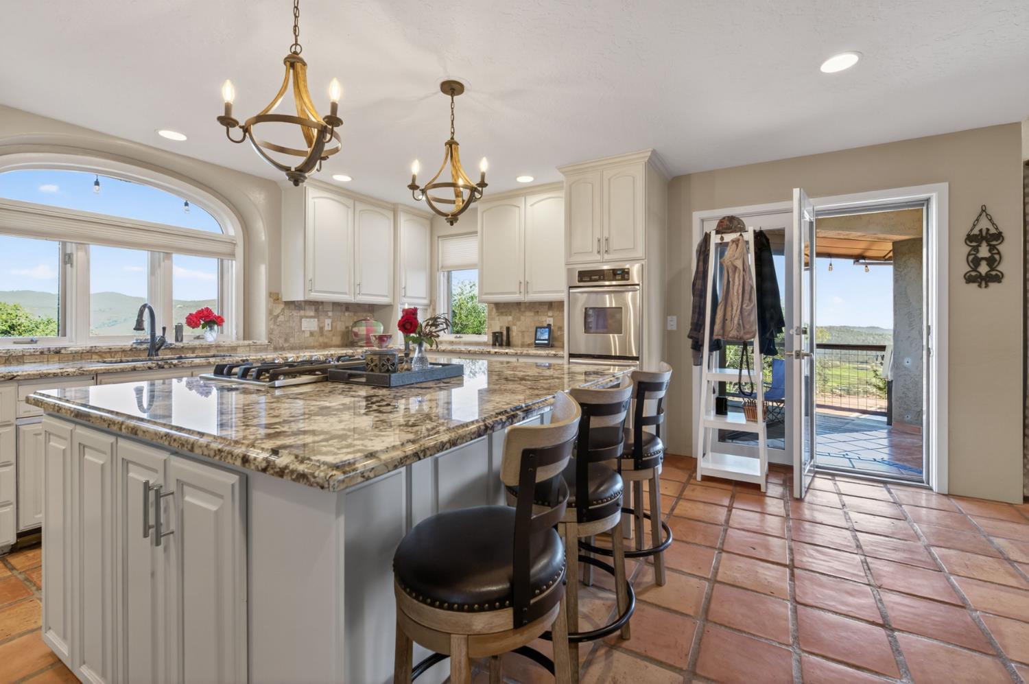 7570 Airola Road Vallecito, CA 95251 - Photo 33 of 90 a kitchen with stainless steel appliances granite countertop a sink a stove a dining table and chairs