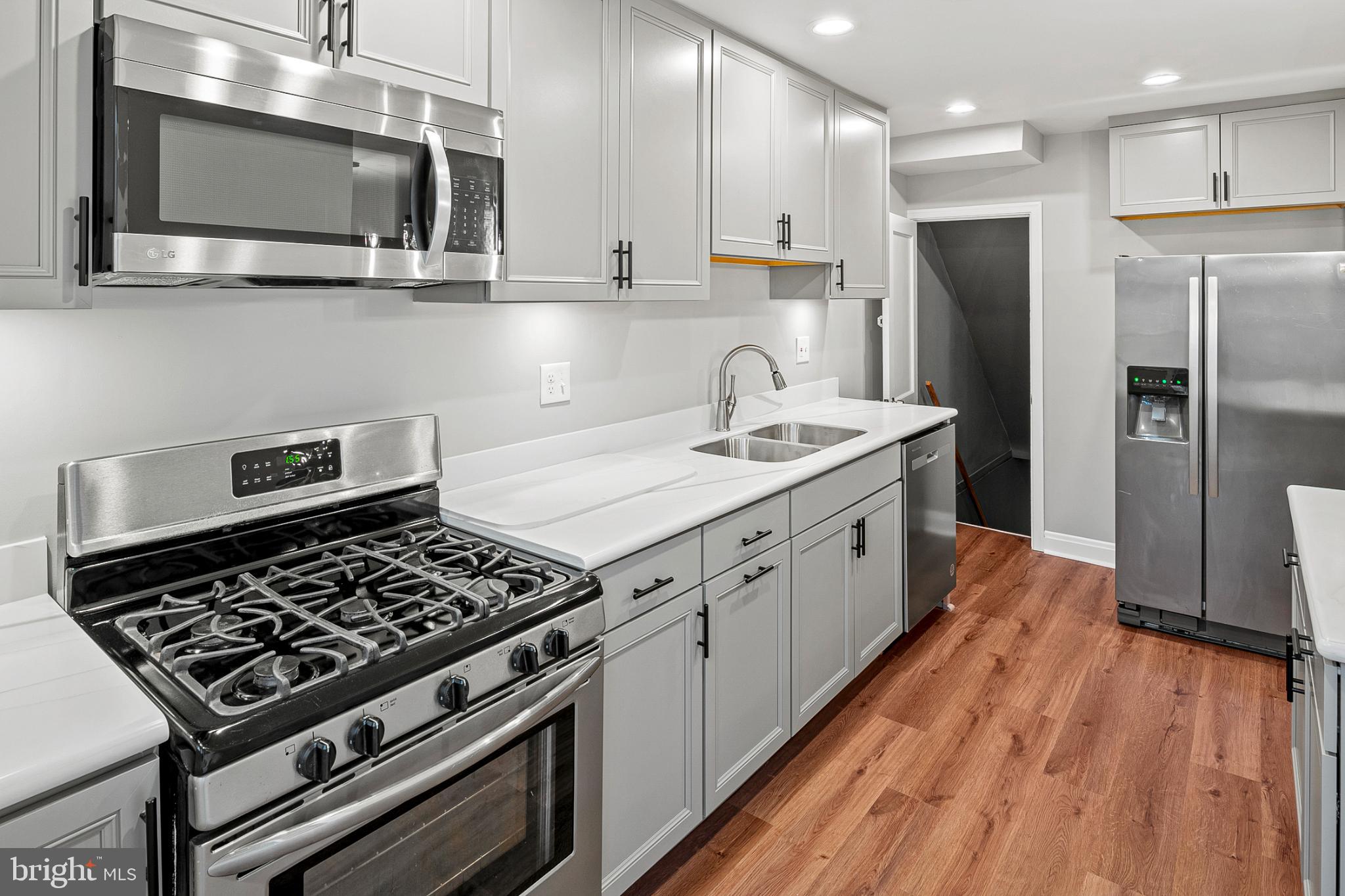 1621 Thetford Road Towson, MD 21286 - Photo 11 of 31 a kitchen with stainless steel appliances granite countertop a stove a refrigerator and a microwave