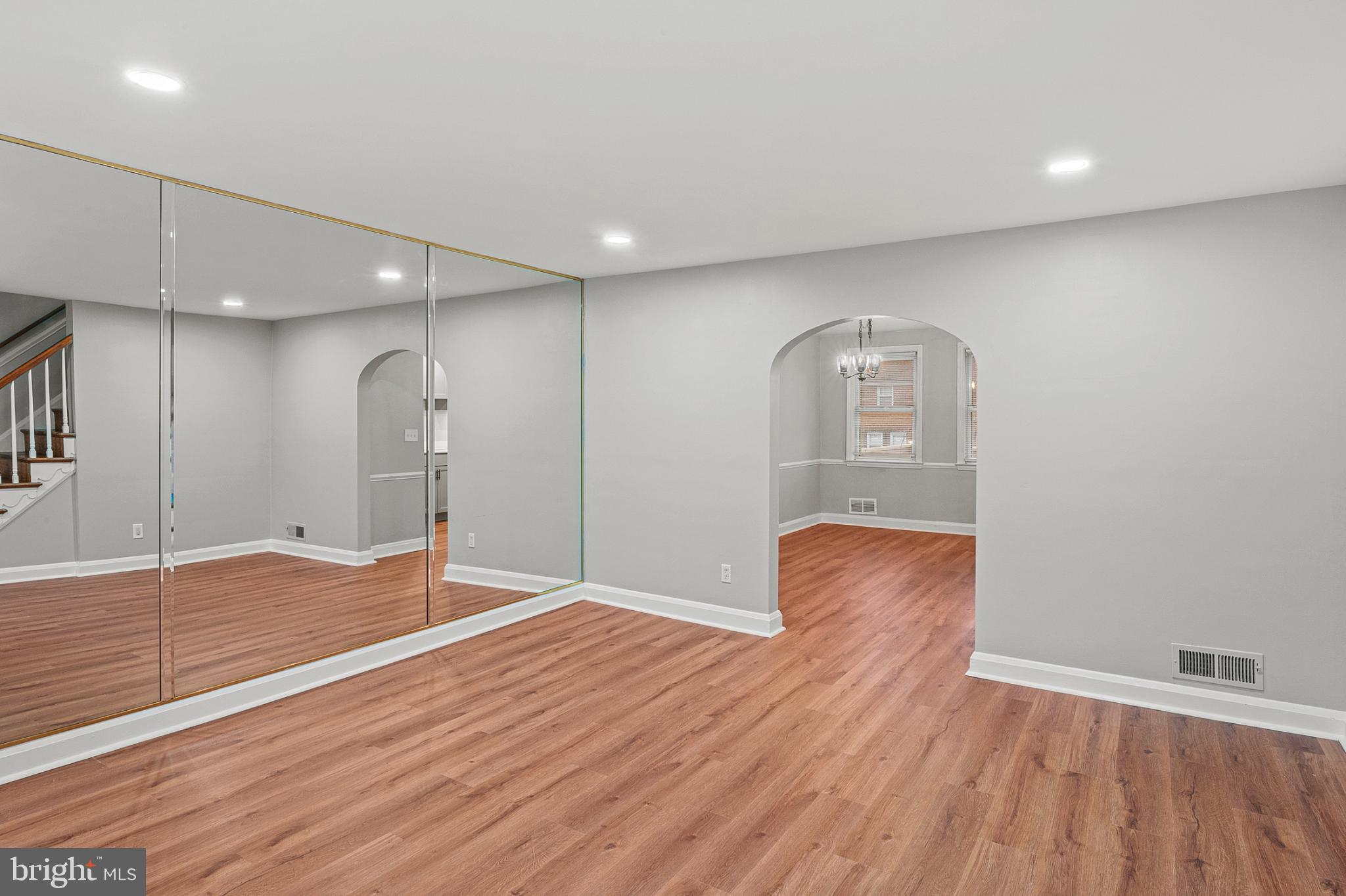1621 Thetford Road Towson, MD 21286 - Photo 6 of 31 a view of an empty room with wooden floor and a window